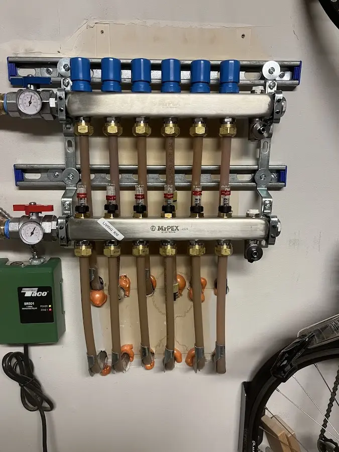 Plumber performing Water Heater Repair at a residential property in Dumont